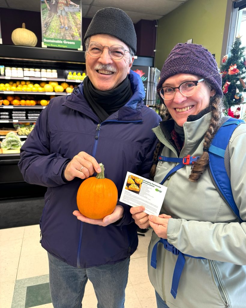 Long-time Member Owners Pose with Free Pumpkin